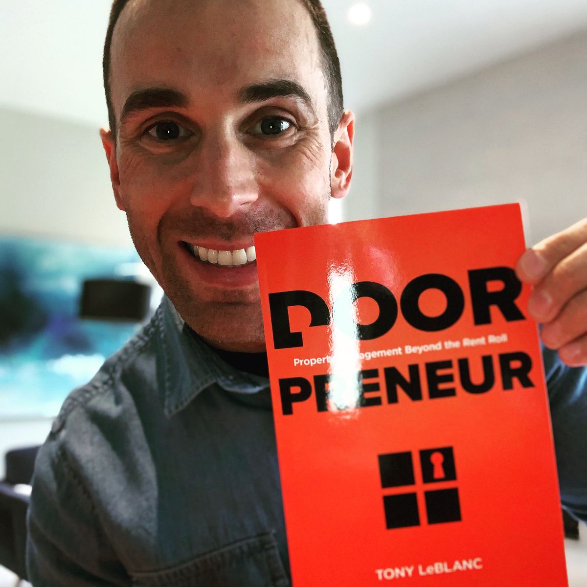 Tony holding a copy of Doorpreneur